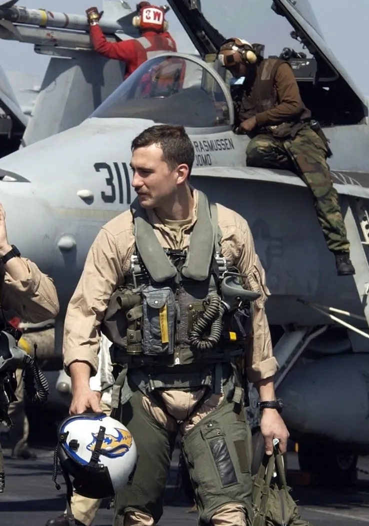 Dr. Monlux walking the carrier deck in flight gear